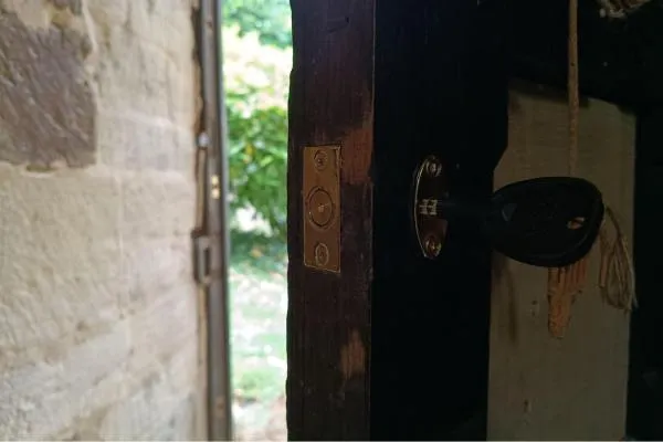 Key-operated rack bolt fitted to a wooden door for additional security