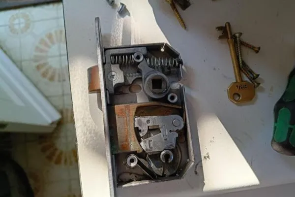 Opened lock case being inspected during a broken lock repair