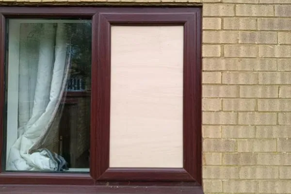 Window secured with temporary boarding following property damage