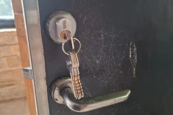 Keys hanging from a commercial door lock serviced in Irthlingborough.