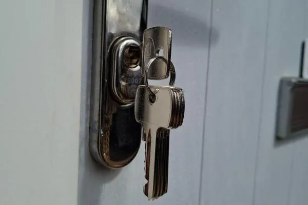 Keys in a door lock following emergency locksmith work in Irthlingborough.