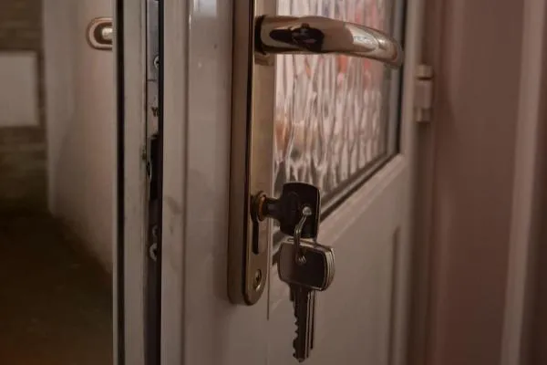 uPVC door handle and Euro cylinder with keys inserted during an emergency locksmith call-out in Raunds.