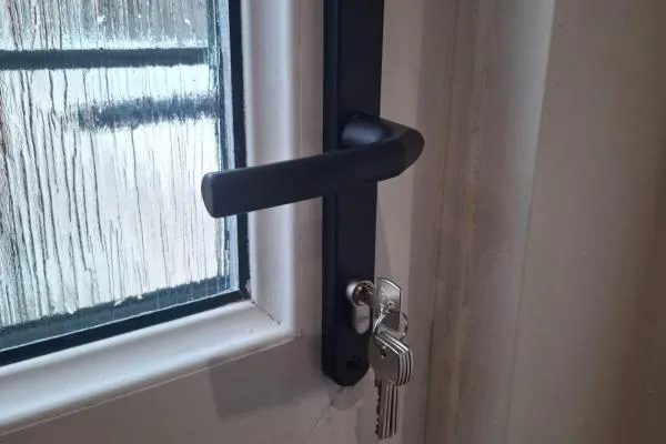 Euro cylinder fitted to a glazed entrance door with keys inserted