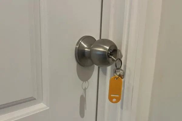 Locking door knob fitted to an internal panelled door with key inserted