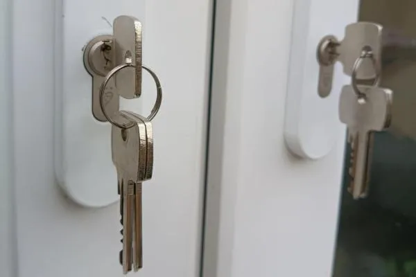 Keys in newly changed locks on white uPVC doors in Wellingborough.