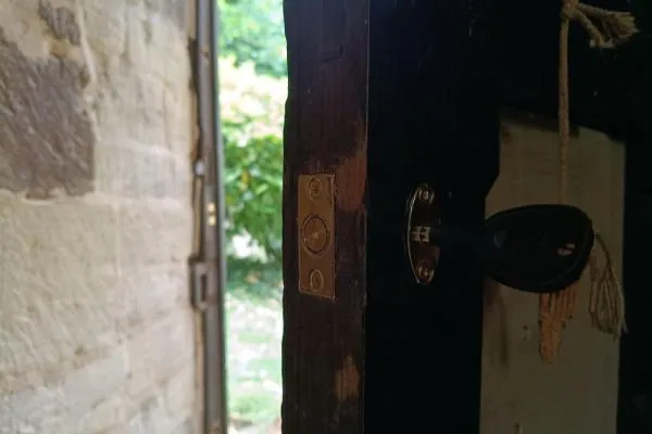 New lock fitted to a wooden door with the key inserted in Raunds