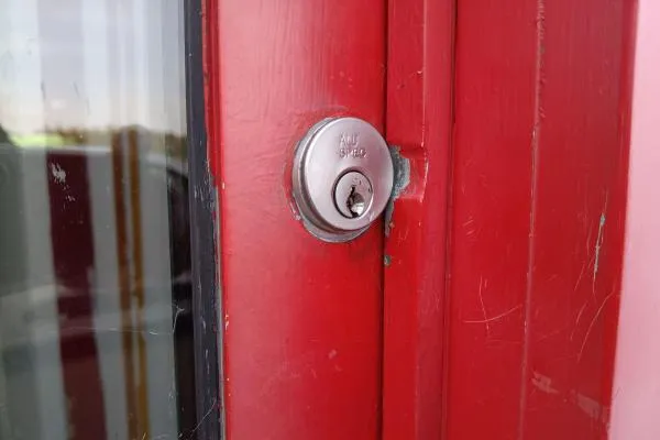 Damaged door lock requiring emergency locksmith access