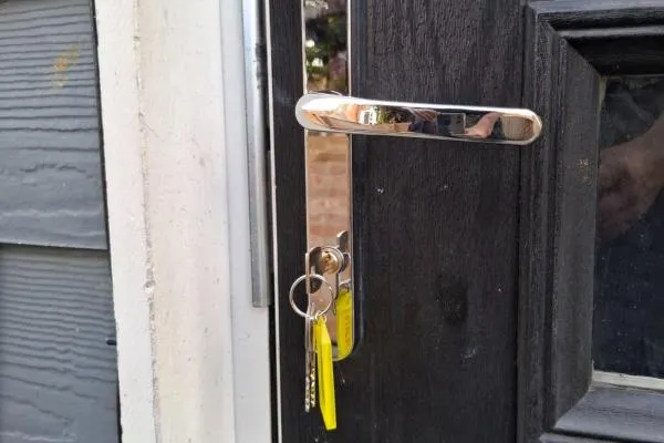 Composite front door lock and chrome lever handle following locksmith services in Irchester.