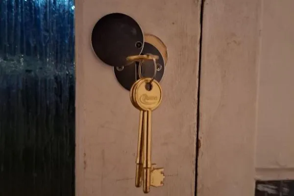 House keys left hanging in a front door lock