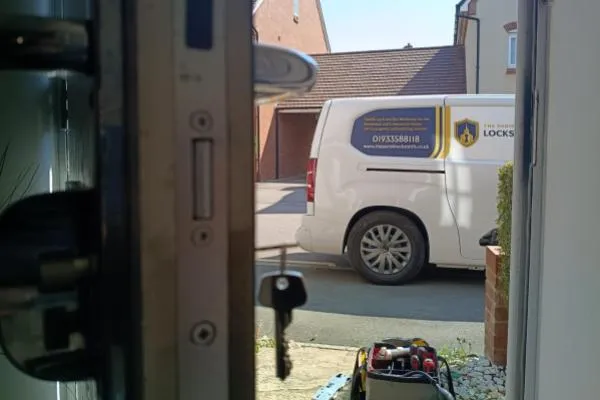 New key in a door lock with The Parish Locksmith van outside