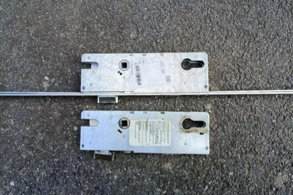 Old and replacement multipoint locking mechanisms photographed during a door lock repair in Rushden.