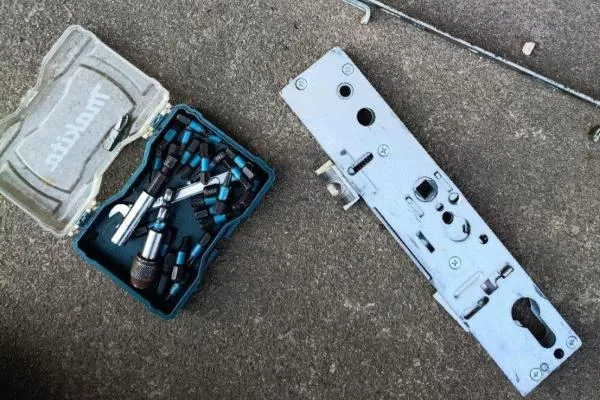 Removed multipoint lock gearbox beside locksmith tools during a repair in Wellingborough.