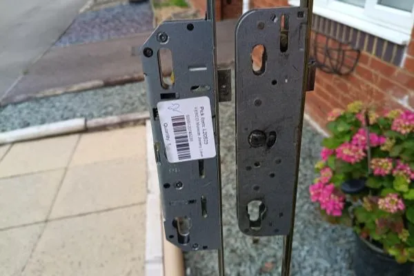 Old and replacement multipoint lock cases compared before installation