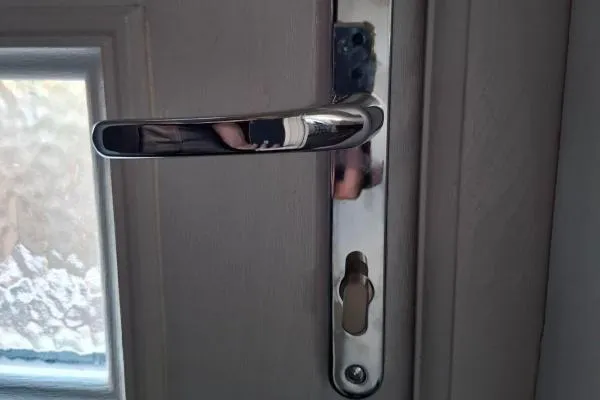 Lever handle and cylinder lock fitted to a residential door in Higham Ferrers.