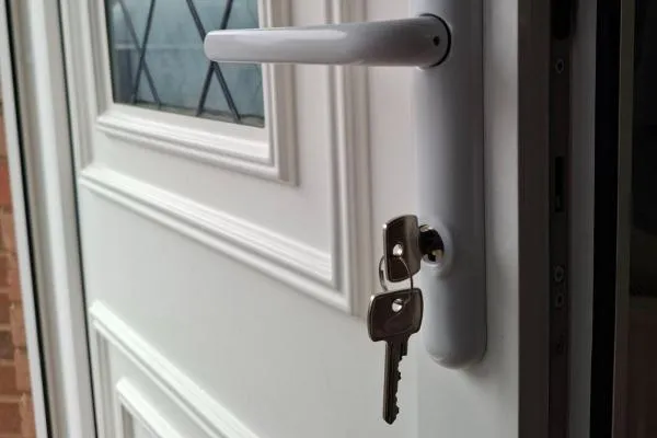 Keys in a residential door lock following locksmith work in Irthlingborough.