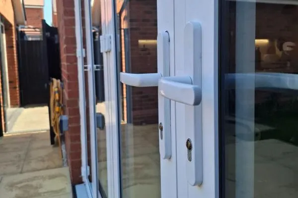 Residential locksmith in Raunds working on Euro cylinder locks fitted to Bi-fold doors.