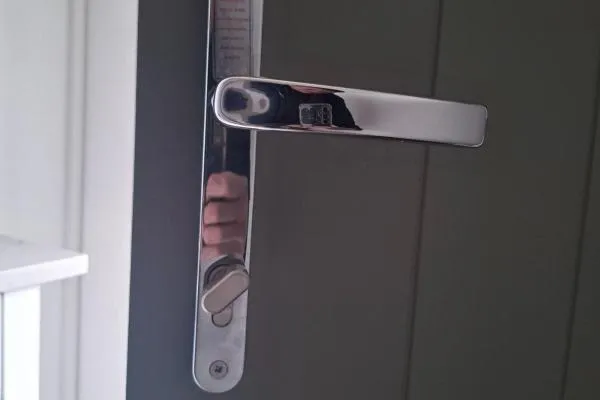 Chrome lever handle and thumbturn lock fitted to a dark composite door in Wellingborough.