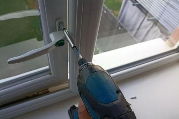 uPVC window handle being removed during a window repair