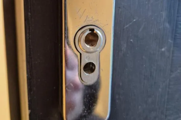 Drilled-out euro cylinder showing burglary damage to a residential door lock