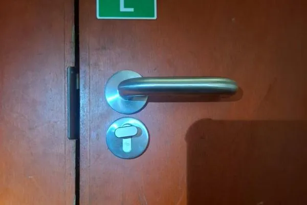 Chrome handle and cylinder on a commercial door in Bozeat