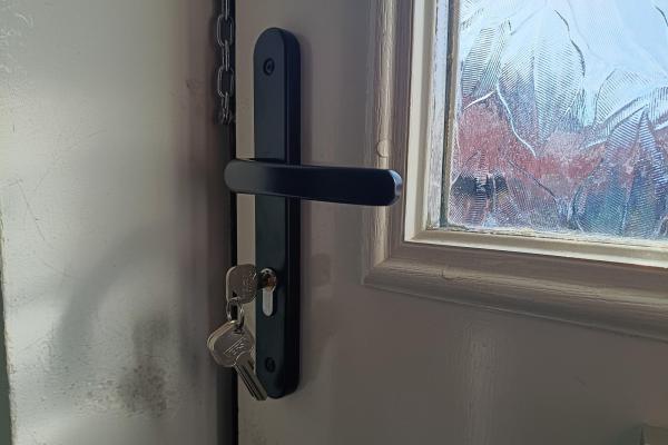 Residential door handle with lock and keys fitted to an entrance door
