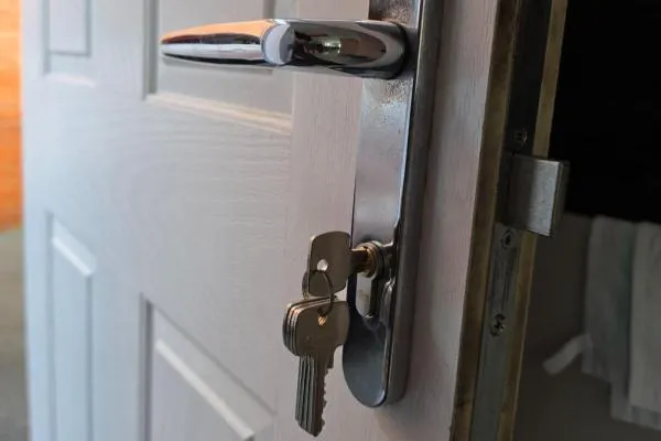 Great Harrowden locksmiths repairing a lock on a white door