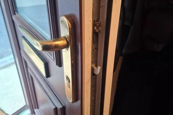 Brass handle and locking mechanism on a brown uPvc door after repair in Bozeat