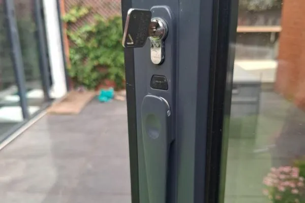 Key testing a repaired door lock in Finedon