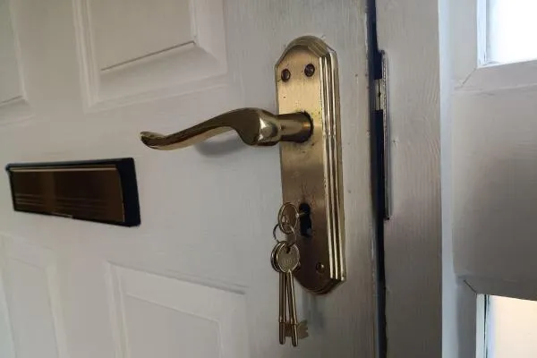 Door lock and handle with keys during locksmith work in Finedon