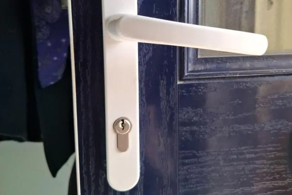 White handle and chrome cylinder on a blue residential composite door in Bozeat