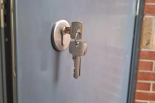 Commercial locksmith in Ringstead fitting a replacement lock