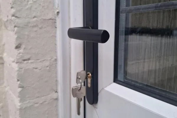 Residential locksmith in Ringstead fitting a replacement door lock