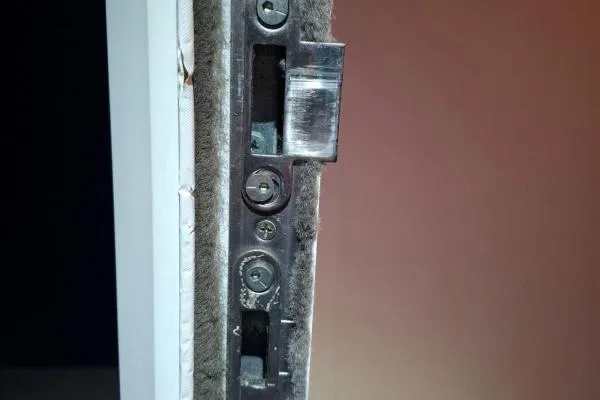 Close-up of a multipoint door locking mechanism and adjustable keep, illustrating door repair services in Castle Ashby.