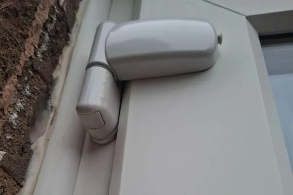 Euro cylinder lock with keys inserted into a uPVC door during lock repair.