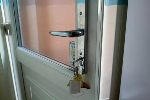 White uPVC entrance door with silver handle and euro cylinder lock, illustrating residential locksmith services in Castle Ashby.