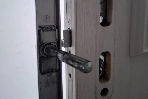 Exposed multipoint door locking mechanism with handle spindle, illustrating multipoint lock repairs in Castle Ashby.
