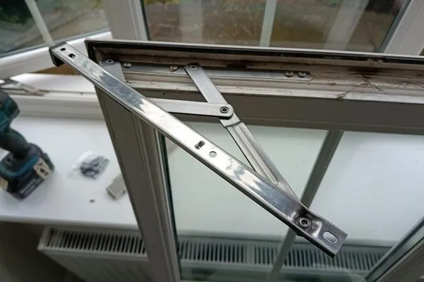 New hinge fitted on a uPVC window